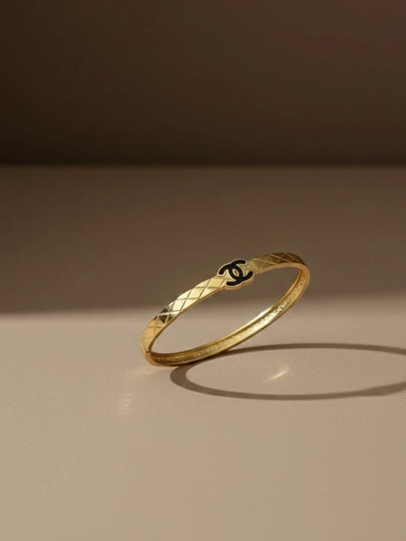 Women wearing golden logo kada
