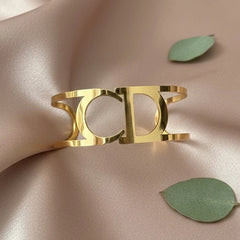 Women wearing golden cuff bracelet

