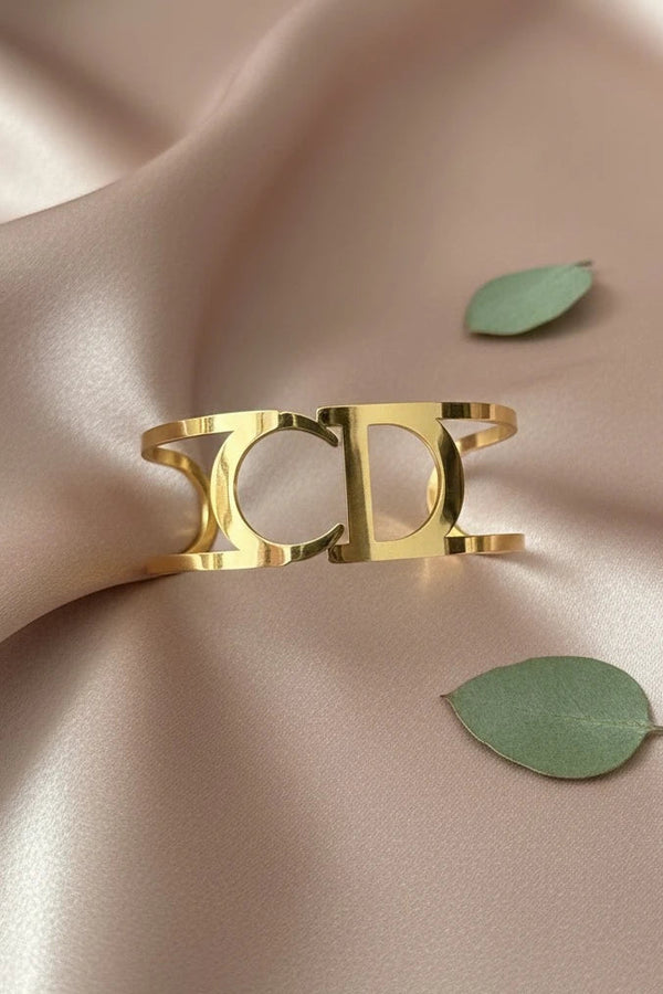 Women wearing golden cuff bracelet
