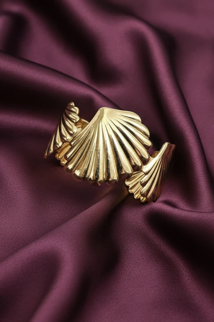 Women wearing golden shell bracelet
