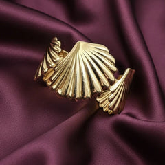 Women wearing golden shell bracelet
