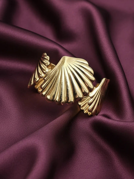 Women wearing golden shell bracelet
