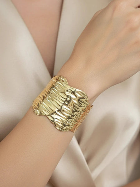 Women wearing golden cuff bracelet
