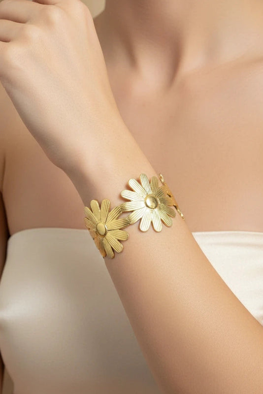 Women wearing golden floral bracelet
