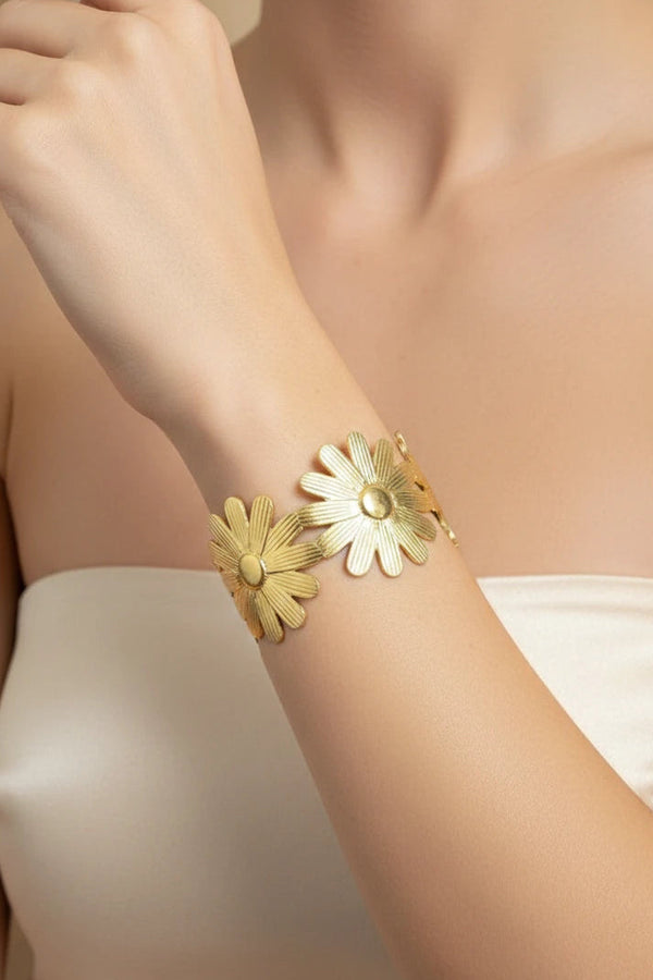 Women wearing golden floral bracelet
