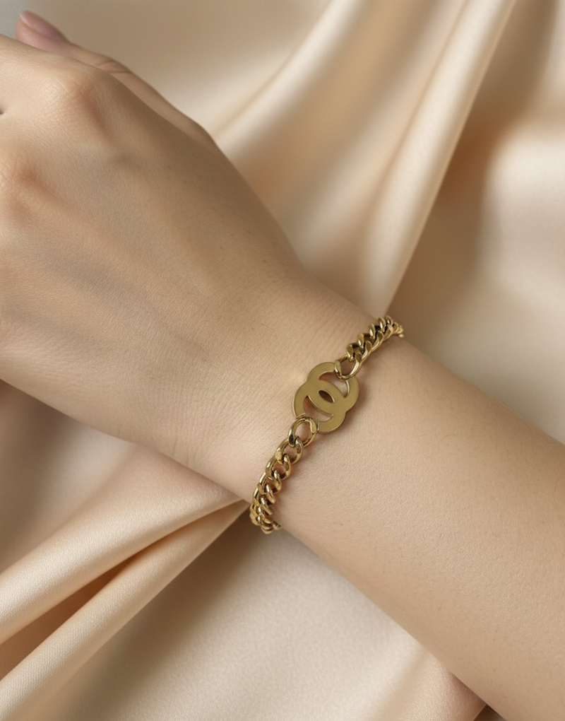 Amaura Golden Emblem Chain Bracelet On Hand
