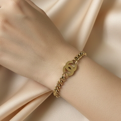 Amaura Golden Emblem Chain Bracelet On Hand