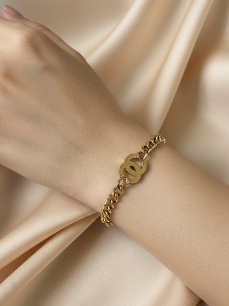 Amaura Golden Emblem Chain Bracelet On Hand